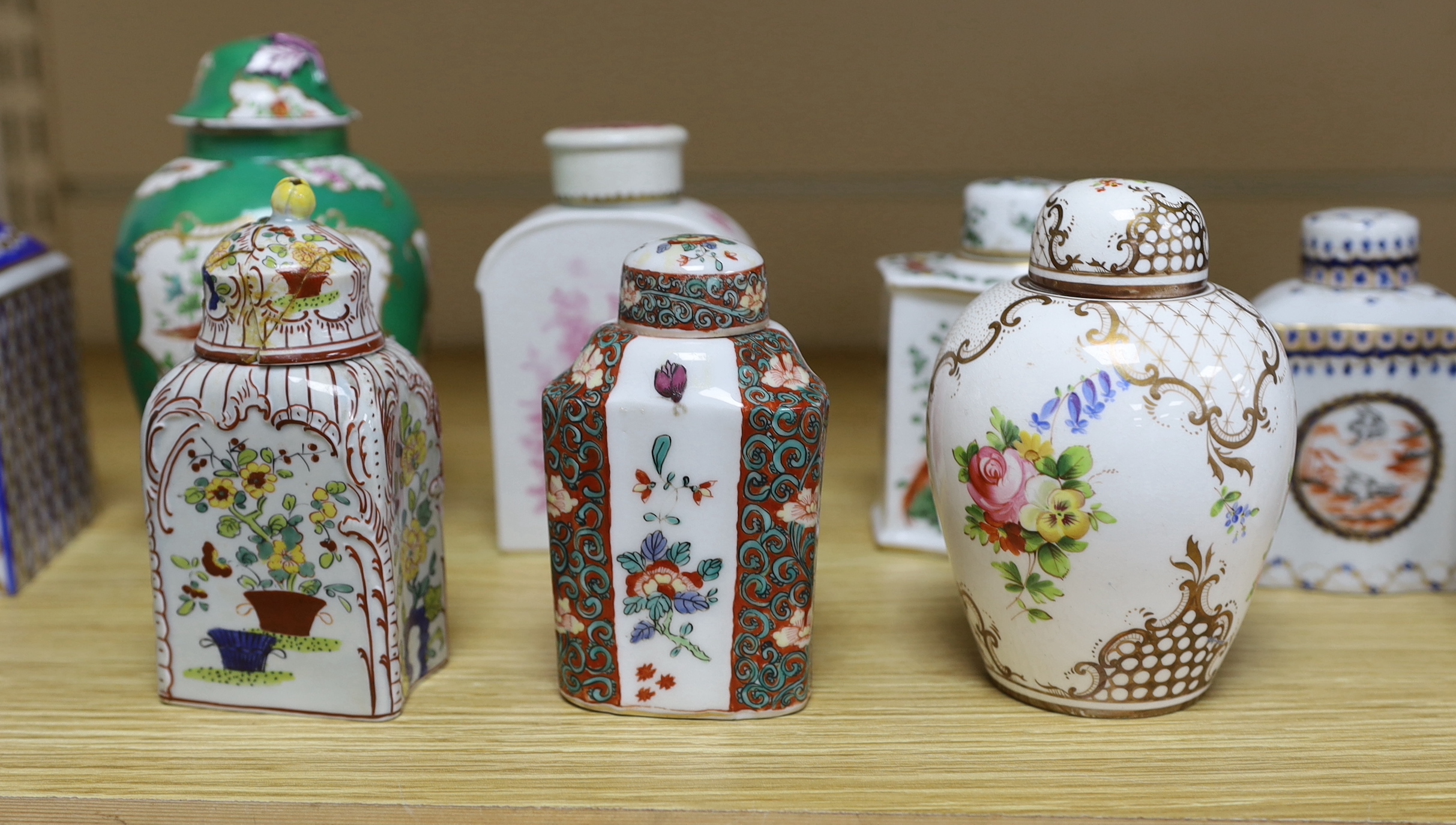 A collection of Paris porcelain tea canisters, imitating Sevres, Chinese export etc. tallest jar and cover 15cm high